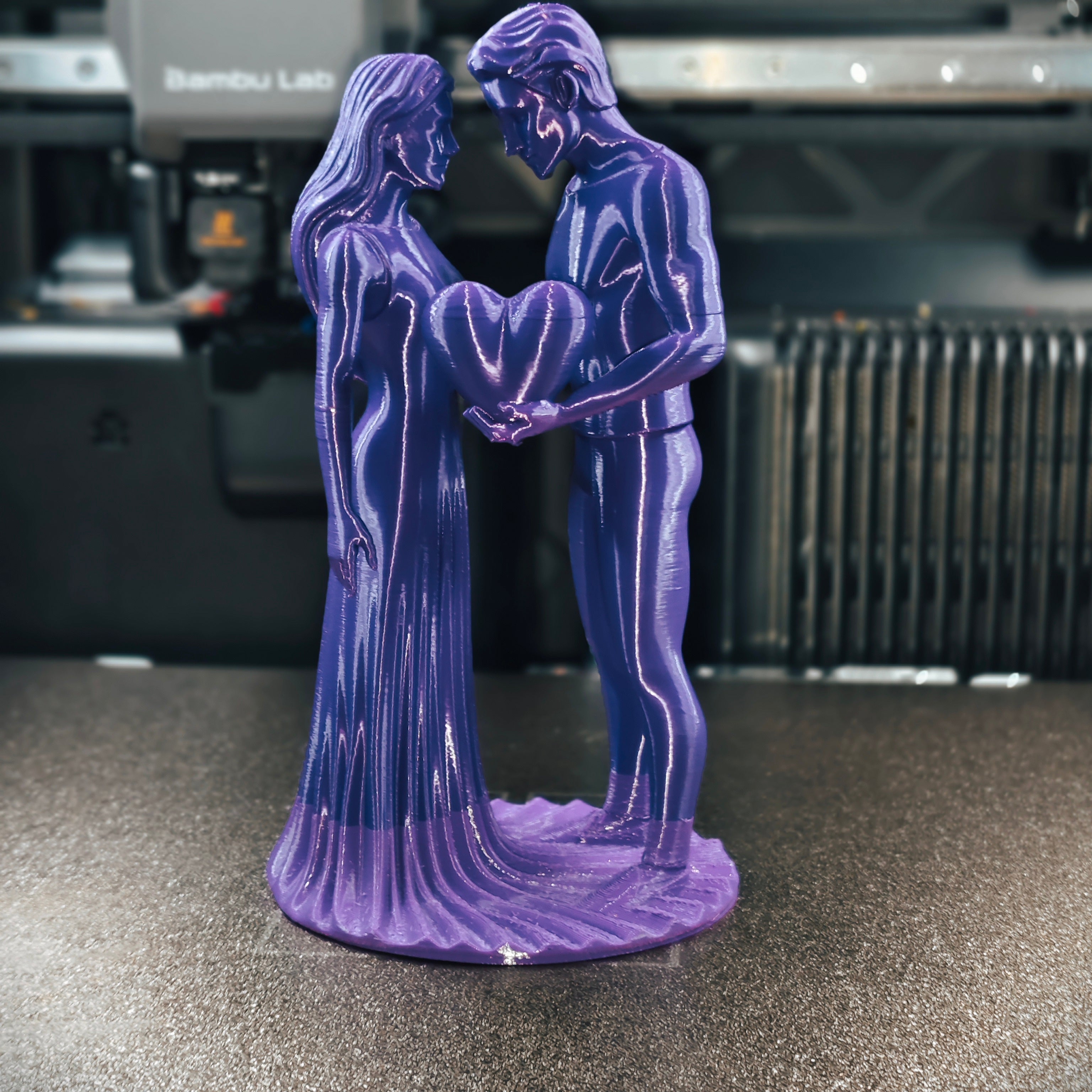 Romantic Couple with Heart Statue